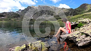 Woman hiker and Lake Gentau in French Pyrenees. Mountains, valley, laggon