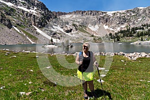 Woman hiker at Lake Solitude from the hiking trail in Grand Teton National Park Wyoming