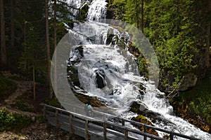 Woman hiker looking at waterfall