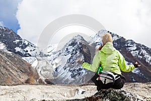 Woman Hiker Meditating on Rocks in Himalaya Mountains, Nepal