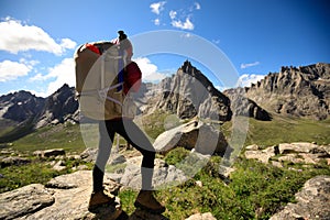 Woman hiker on mountain top rock