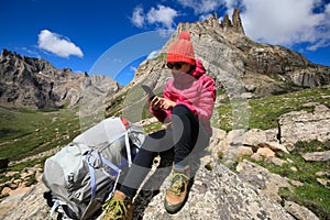 Woman hiker on mountain top rock