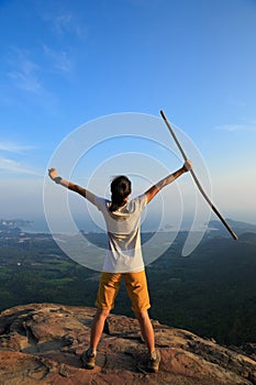 woman hiker open arms hiking on mountain peak