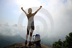 woman hiker open arms hiking on mountain peak