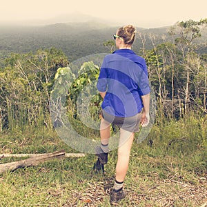 Woman hiker overlooking forest