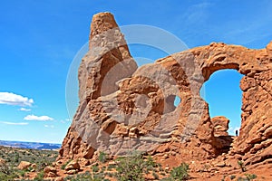 Woman hiker poses at Turret Arch at Arches National Park, Utah