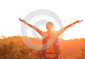 Woman hiker raised arms mountain top