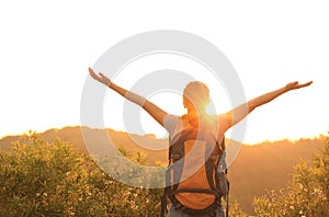 Woman hiker raised arms mountain top