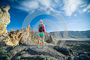 Woman hiker reached mountain top, backpacker adventure photo