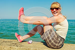 Woman hiker relaxing on sea coast