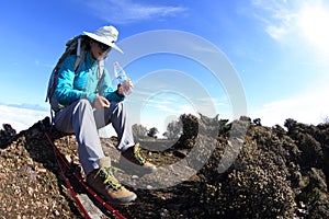Woman hiker rest and drinking bottled water