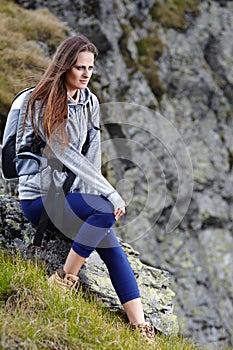 Woman hiker resting on a rock