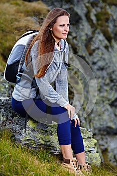 Woman hiker resting on a rock