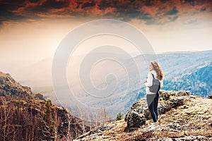 Woman hiker standing on top of the mountain.