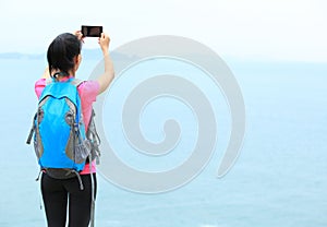 Woman hiker taking photo