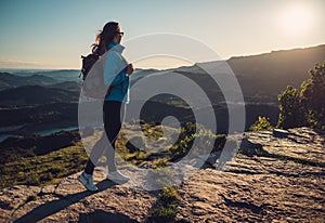 Woman hiker on a top of a mountain