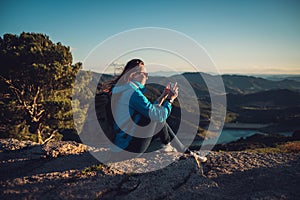 Woman hiker on a top of a mountain