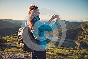 Woman hiker on a top of a mountain