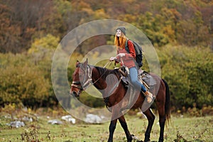 woman hiker travel mountains nature riding horse landscape