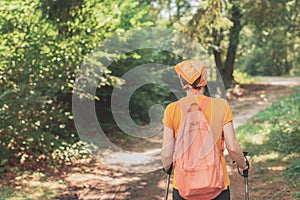 Woman hiker trekking and walking in forest