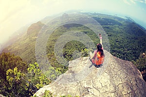 Woman hiker use smartphone taking photo on seaside mountain top