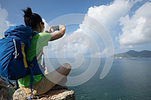 woman hiker using smartphone on hiking travel