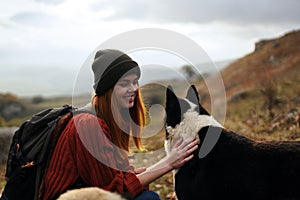 woman hiker walking the dog in the mountains nature travel landscape