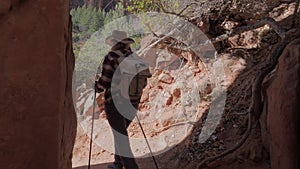 Woman Hiker Walking Out Of The Cave Between The Rocks Of The Canyon On Outside