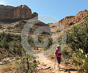 A Woman Hikes Down from Sedona`s Famous Cathedral Rock