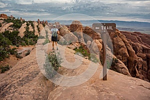 Woman Hikes Down Slickrock in Arches National Park