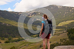 Woman hiking alone, with her protective mask on her face