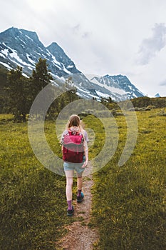 Woman hiking alone in mountains travel adventure