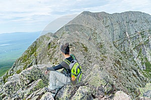 Woman hiking along Knife Edge Trail of Mount Katahdin Northeast Piscataquis Maine USA