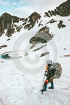 Woman hiking with backpack and ice axe Travel Lifestyle survival concept