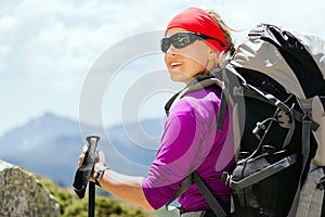 Woman hiking with backpack in mountains