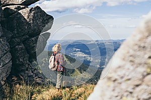 Woman hiking with backpack and trekking poles. Nature tourism in Ukrainian Carpathian mountains