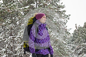 Woman Hiking with Big Backpack in Beautiful Winter Forest