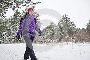 Woman Hiking with Big Backpack in Beautiful Winter Forest