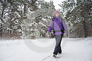 Woman Hiking with Big Backpack in Beautiful Winter Forest