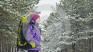 Woman Hiking with Big Backpack in Beautiful Winter Forest