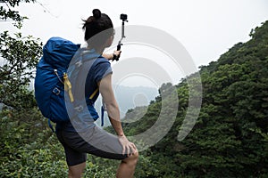 Woman Hiking In Forest Taking A Selfie photo