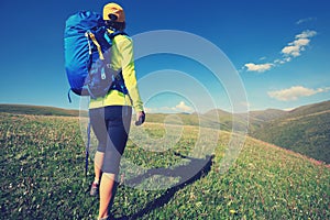 Woman hiking in grassland mountain top