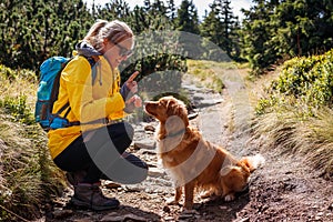 Woman hiking with her dog outdoors