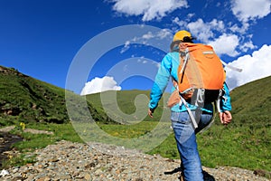 woman hiking on high altitude mountain trail