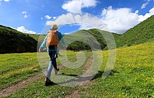 Woman hiking on high altitude mountain trail