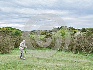 Woman is hiking with hiking sticks