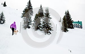 Woman hiking Karkonosze Mountain, Poland with dog