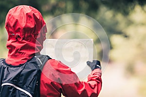 Woman hiking with map in autumn woods