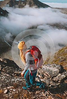 Woman hiking in mountains with red backpack travel trail running activity