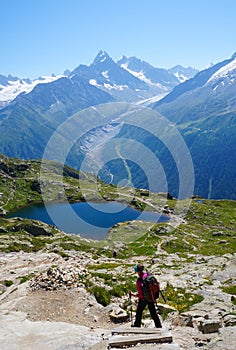 Woman hiking in the mountains on a tourist track